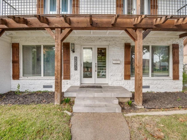 view of exterior entry with crawl space, a balcony, and covered porch