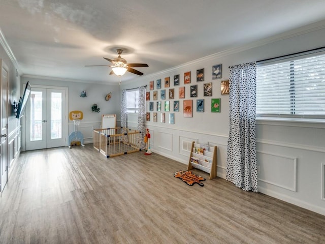 1253 Willow Glen Dr, Dallas, TX 75232 - playroom with a decorative wall, ceiling fan, crown molding, and french doors