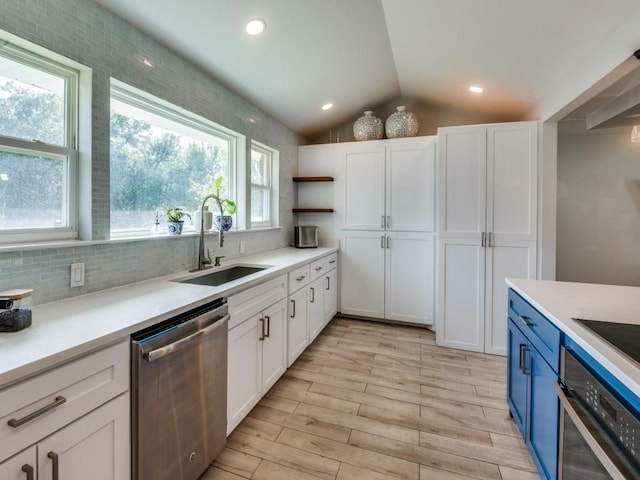 1253 Willow Glen Dr, Dallas, TX 75232 - kitchen featuring open shelves, appliances with stainless steel finishes, vaulted ceiling, white cabinets, and a sink