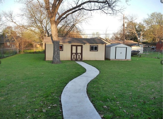 view of yard with a fenced backyard, a shed, and an outdoor structure