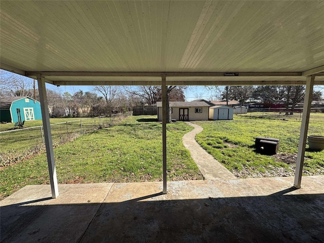 view of patio with a fenced backyard, a storage unit, and an outdoor structure