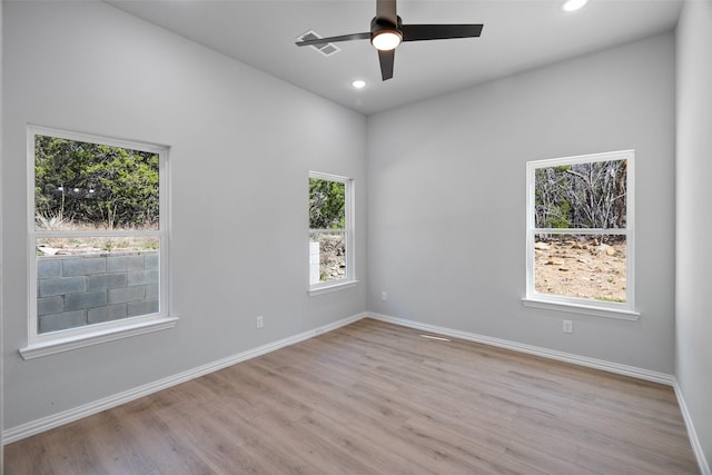 empty room featuring recessed lighting, a ceiling fan, light wood-type flooring, and baseboards