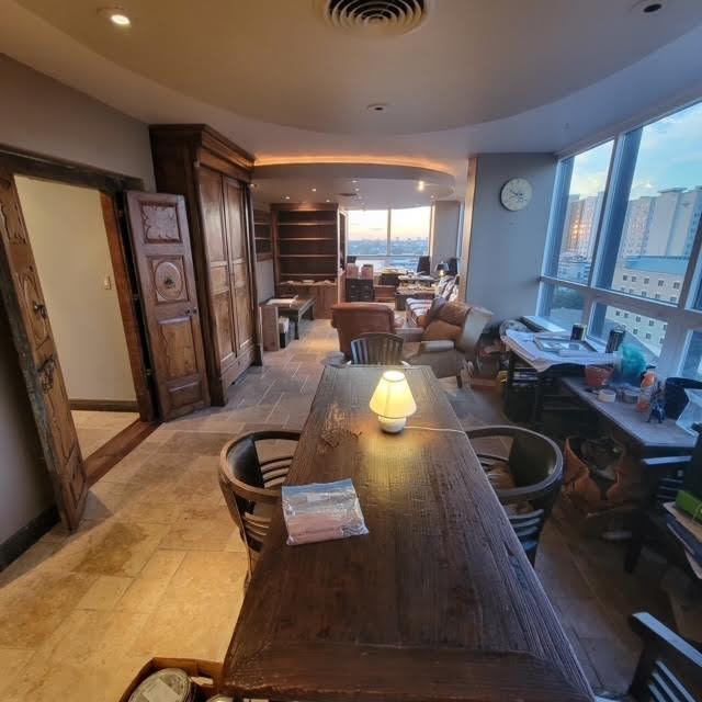 dining room with stone finish floor, plenty of natural light, and visible vents