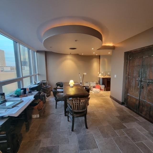 dining area with stone finish floor and baseboards