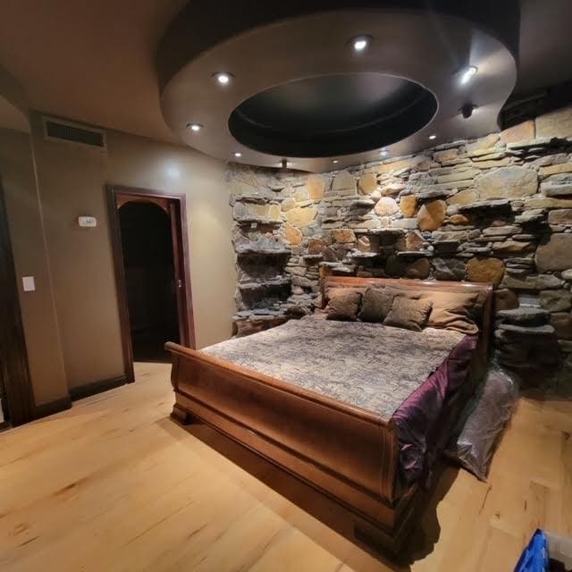 bedroom featuring visible vents and wood finished floors