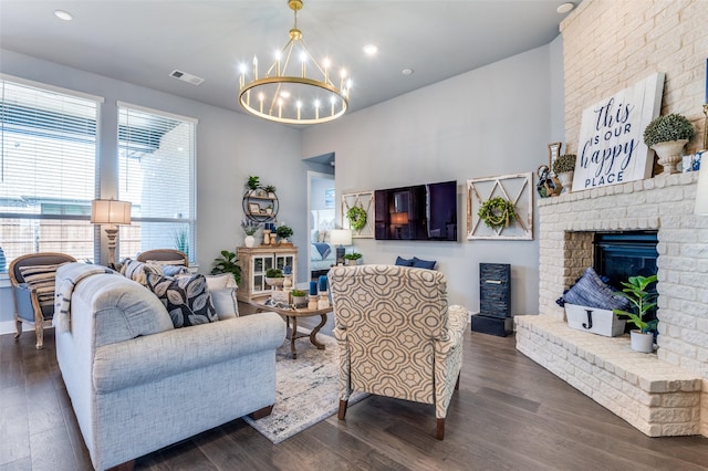 living room featuring a chandelier, visible vents, recessed lighting, a fireplace, and dark wood-type flooring