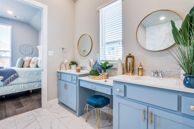 ensuite bathroom featuring visible vents, connected bathroom, plenty of natural light, and marble finish floor