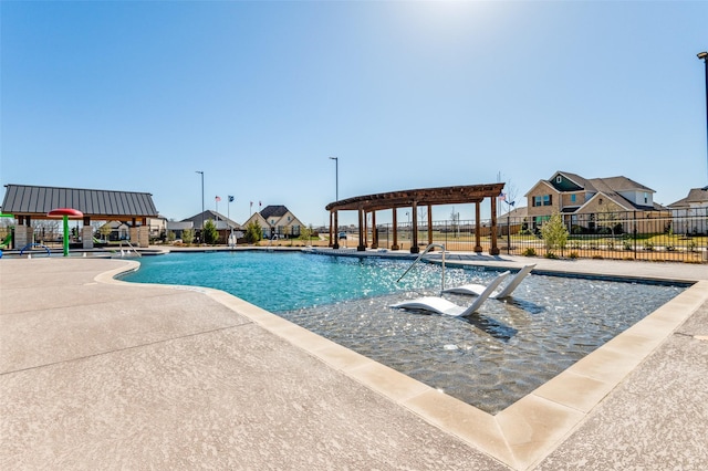 community pool featuring a patio and fence