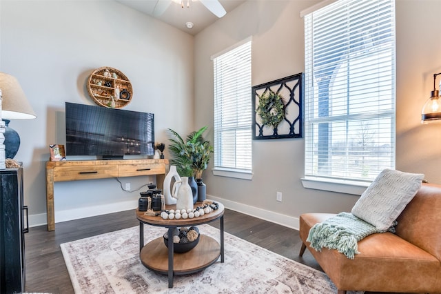 sitting room with ceiling fan, wood finished floors, and baseboards
