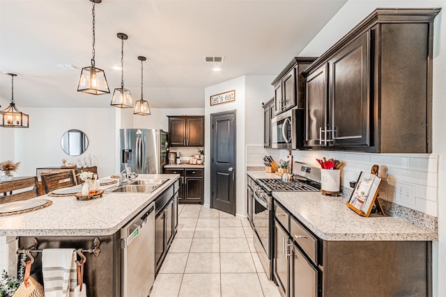 kitchen with visible vents, a sink, tasteful backsplash, appliances with stainless steel finishes, and light tile patterned floors