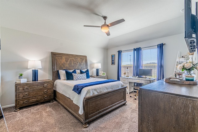 bedroom with lofted ceiling, light colored carpet, baseboards, and ceiling fan