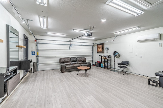 garage with a garage door opener and a wall mounted AC