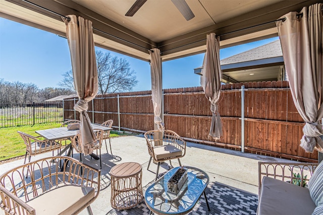 view of patio / terrace featuring a fenced backyard, outdoor dining space, and a ceiling fan