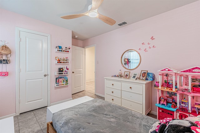 tiled bedroom with a ceiling fan, visible vents, and baseboards