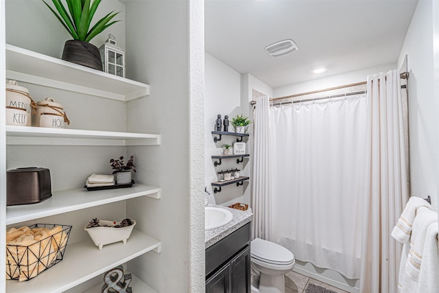 bathroom featuring vanity, shower / bath combo with shower curtain, toilet, and visible vents