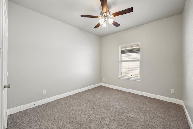 empty room with carpet flooring, a ceiling fan, and baseboards