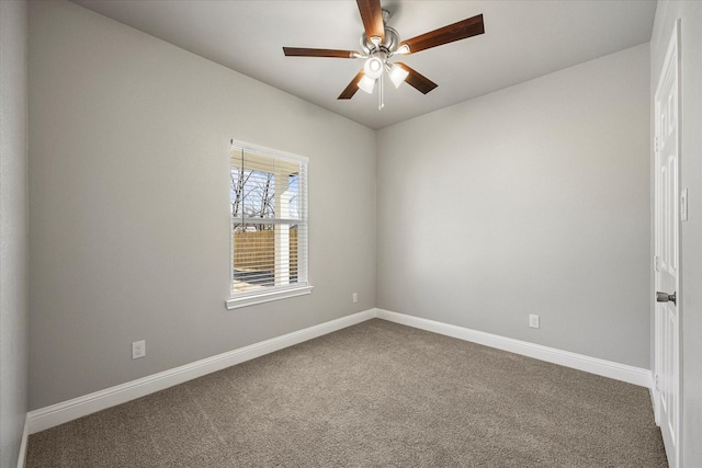 unfurnished room with carpet flooring, ceiling fan, and baseboards