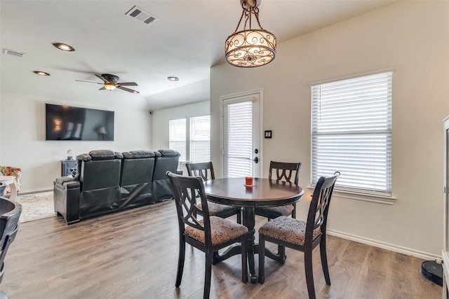 dining space featuring visible vents, baseboards, and light wood finished floors