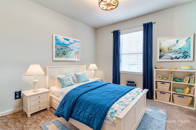 bedroom with light carpet and baseboards