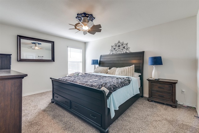 carpeted bedroom with a ceiling fan and baseboards