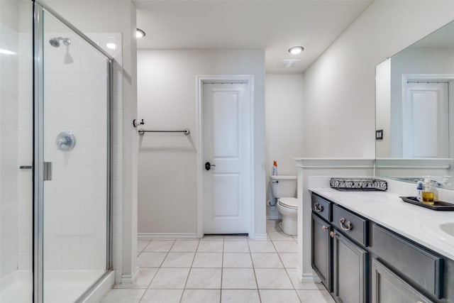 full bathroom with tile patterned floors, toilet, a stall shower, baseboards, and vanity