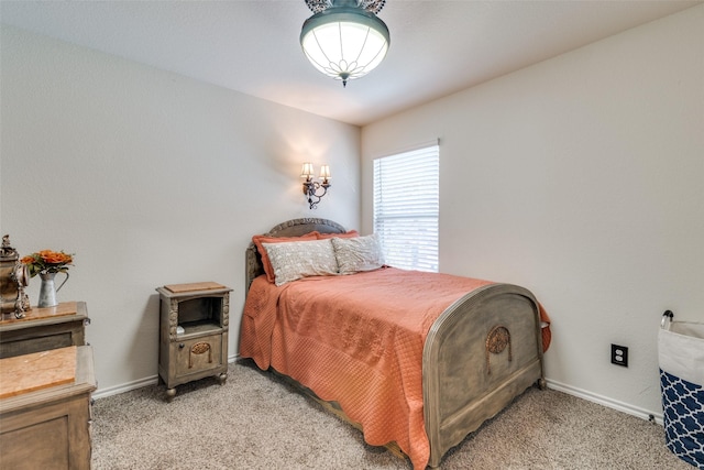 bedroom featuring baseboards and light carpet