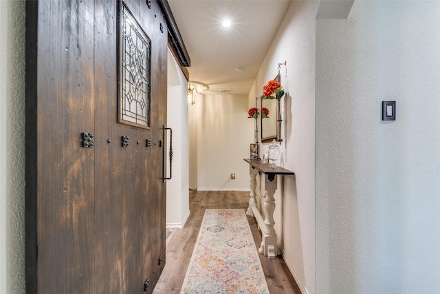 hallway with baseboards and wood finished floors