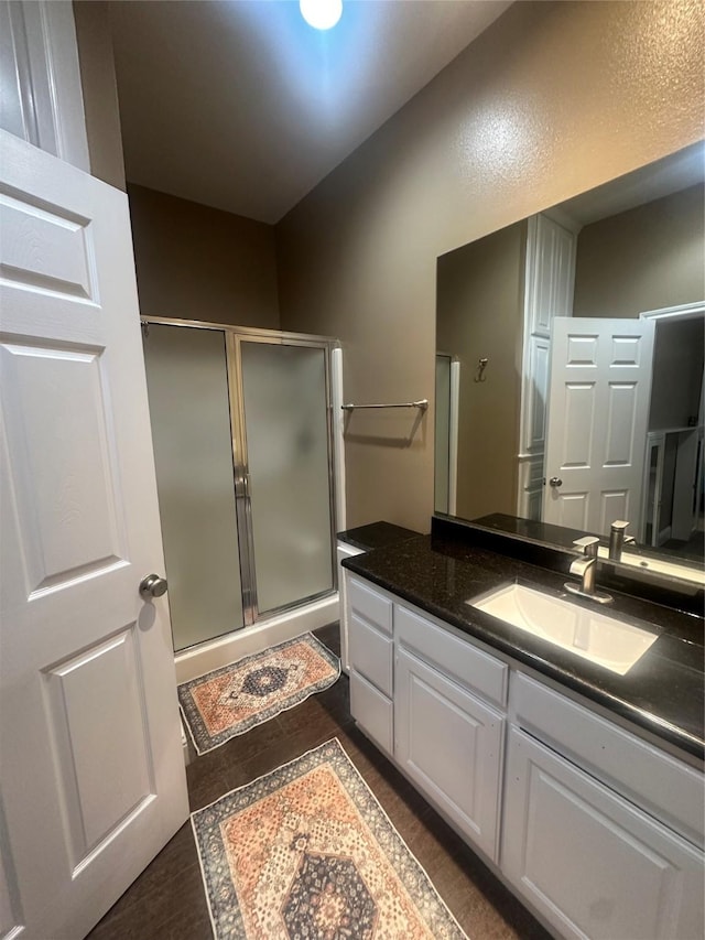 bathroom featuring a stall shower and vanity