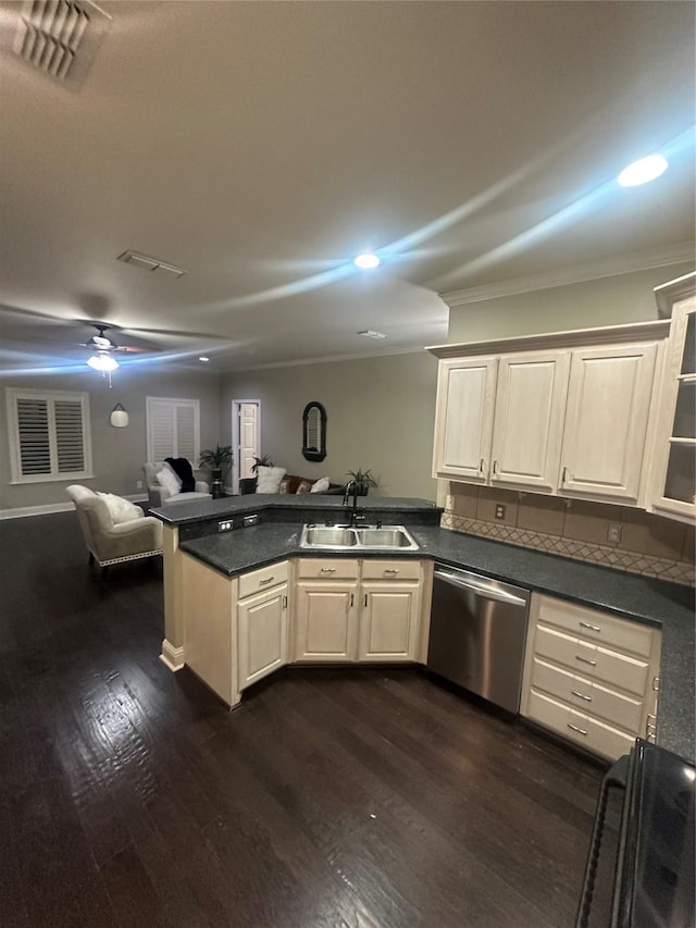 kitchen featuring visible vents, a sink, dishwasher, dark countertops, and open floor plan