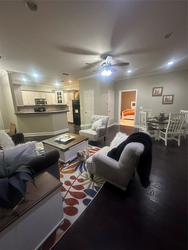 living area with recessed lighting, dark wood-type flooring, ceiling fan, and ornamental molding