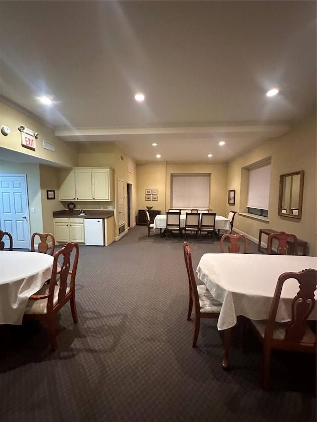 dining space featuring recessed lighting, baseboards, and dark carpet