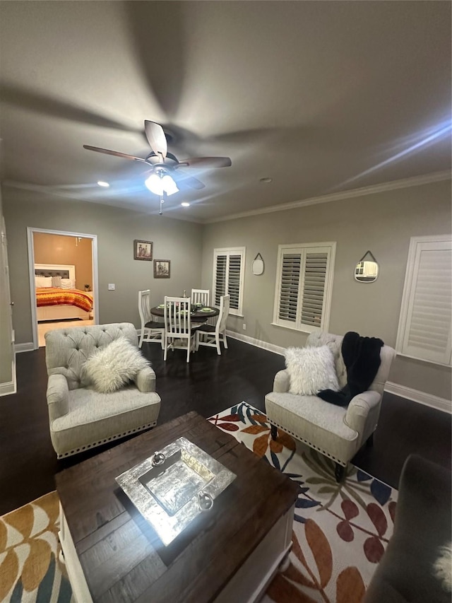 living room featuring crown molding, a ceiling fan, dark wood-type flooring, and baseboards