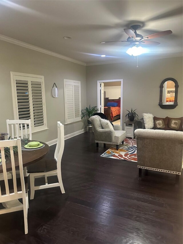 living area featuring wood finished floors, a ceiling fan, baseboards, and ornamental molding