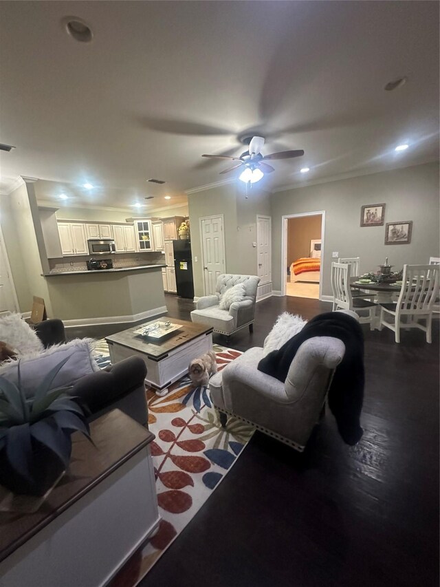 living room with dark wood finished floors, crown molding, recessed lighting, and visible vents