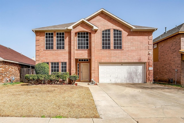 traditional-style house featuring a garage, brick siding, and concrete driveway