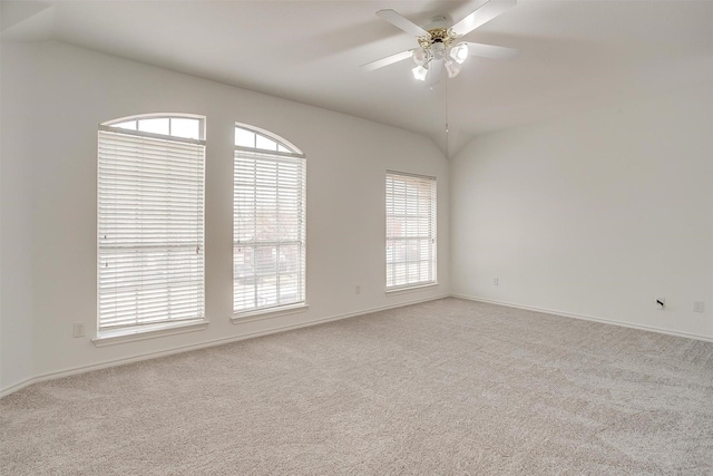 unfurnished room featuring carpet flooring, a ceiling fan, and vaulted ceiling