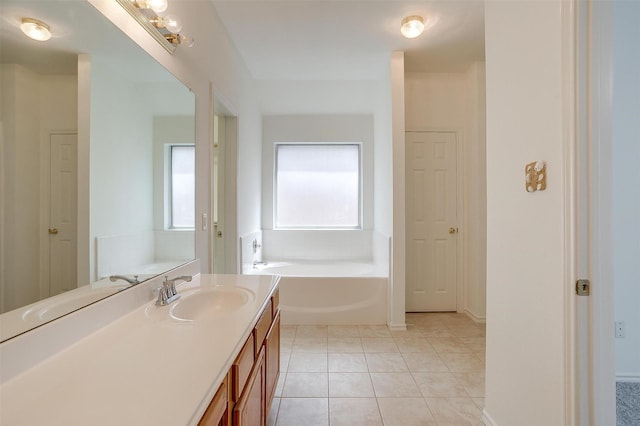 full bathroom featuring tile patterned flooring, a garden tub, and vanity