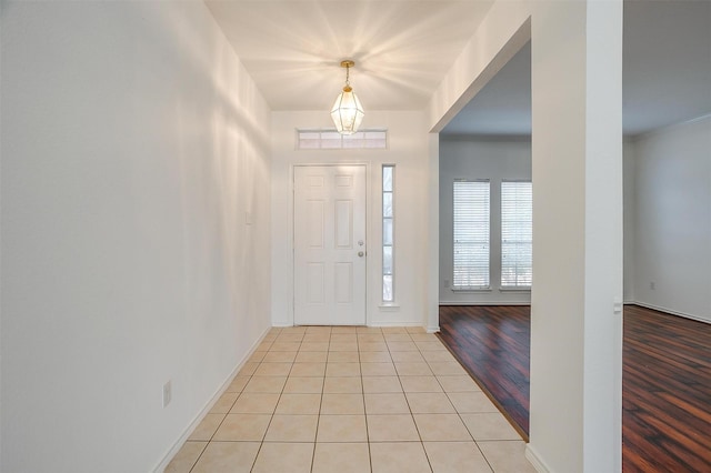 entrance foyer featuring light tile patterned floors and baseboards