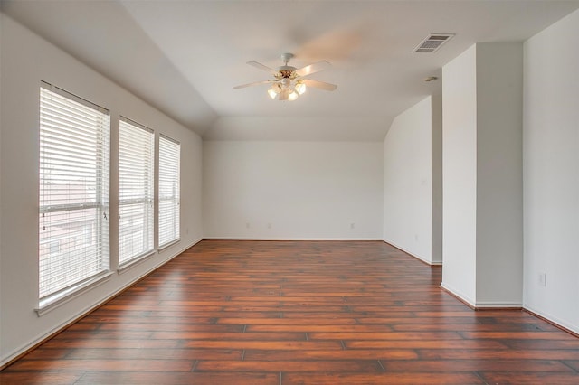 spare room with visible vents, ceiling fan, baseboards, lofted ceiling, and hardwood / wood-style flooring