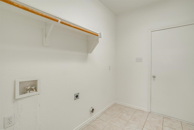 laundry area featuring baseboards, light tile patterned floors, laundry area, hookup for a washing machine, and electric dryer hookup