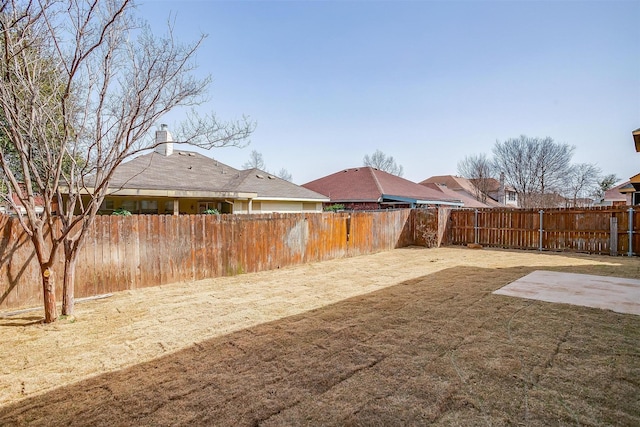 view of yard with a fenced backyard and a patio area