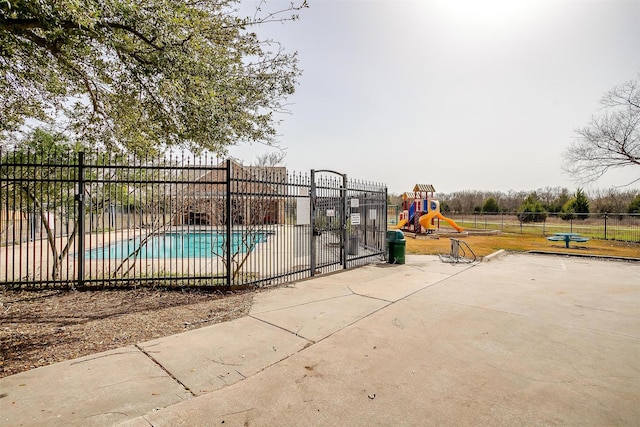 community pool featuring fence and playground community