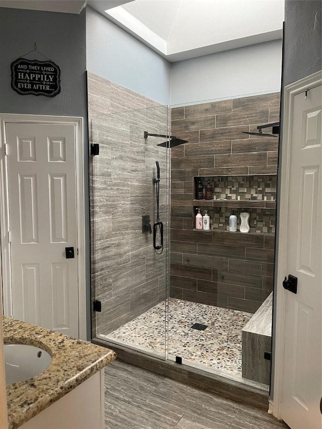 bathroom with a stall shower and vanity