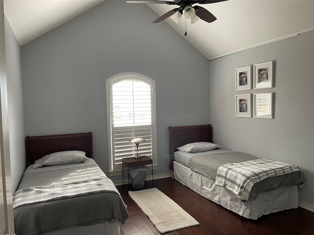 bedroom featuring vaulted ceiling, baseboards, a ceiling fan, and wood finished floors