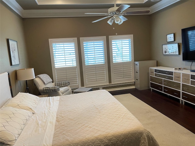 bedroom featuring dark wood-style floors, multiple windows, crown molding, and ceiling fan