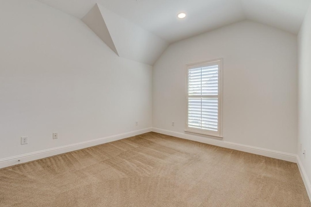 interior space featuring recessed lighting, baseboards, light colored carpet, and vaulted ceiling