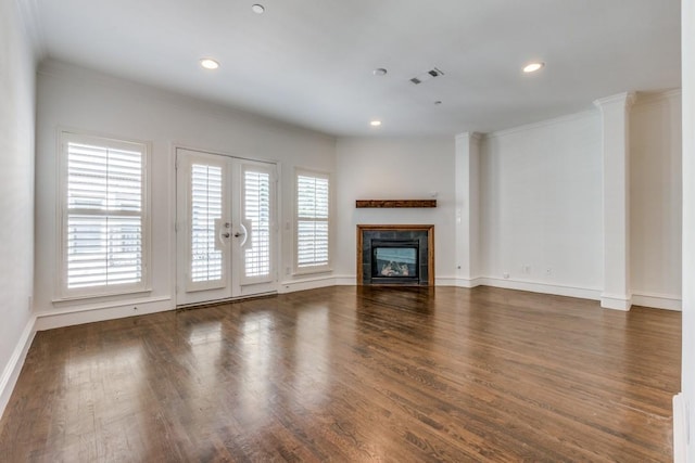 unfurnished living room featuring visible vents, a glass covered fireplace, wood finished floors, recessed lighting, and crown molding