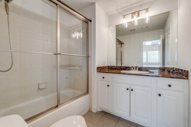 full bath featuring vanity, visible vents, shower / bath combination with glass door, tile patterned flooring, and toilet