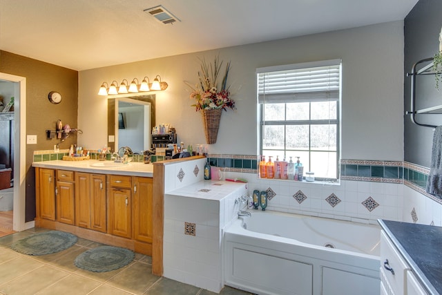 full bath with visible vents, a bath, vanity, and tile patterned flooring