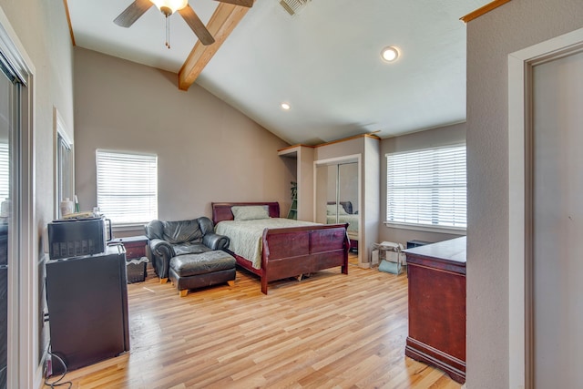 bedroom featuring multiple windows, vaulted ceiling with beams, visible vents, and light wood-type flooring